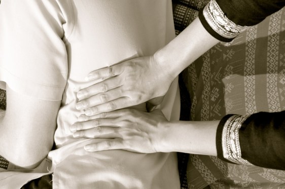 working on line 1 on a client's back in Traditional Thai Massage, Wat Po style